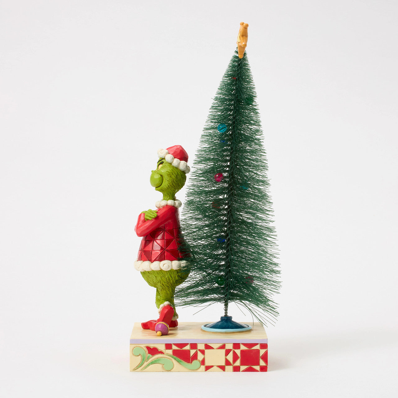 Grinch with Arms Crossed by Christmas Tree